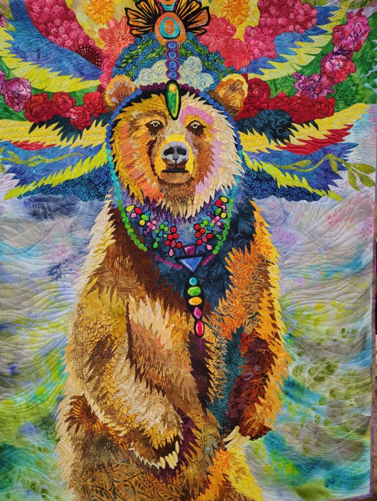 A regal mother brown bear in fabric and thread fiber art